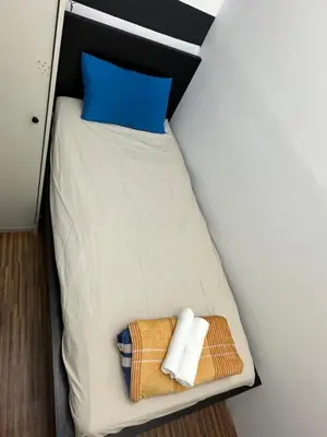 a small bed with two towels on top of it at City Lux Stay In Al Barsha 1Near Mall of Emirates in Dubai