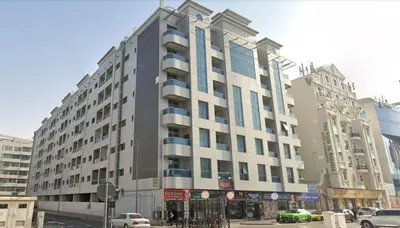 a large building on a city street with cars at City Lux Stay In Al Barsha 1Near Mall of Emirates in Dubai