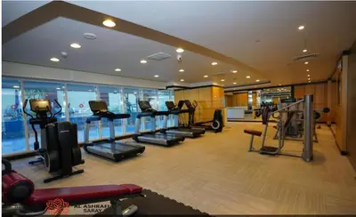a gym with treadmills and ellipticals in a building at Dreamstay 2 BR in Business Bay in Dubai
