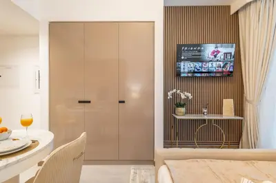 a living room with a table and a glass door at Gala Guests - Urban Oasis Apartments Near Burj Khalifa & Downtown Dubai in Dubai