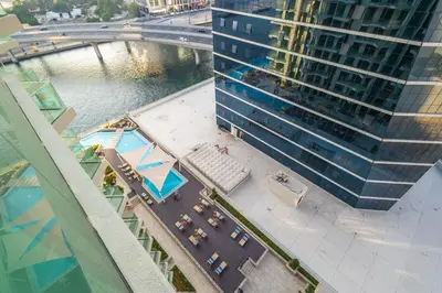 an overhead view of a building and a street with cars at Gala Guests - Urban Oasis Apartments Near Burj Khalifa & Downtown Dubai in Dubai