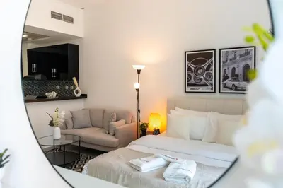 a hotel room with a bed and a couch at Tranquil Studio at Botanica in Dubai