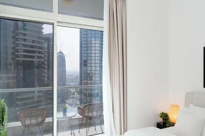 a room with a large window with chairs and a table at Tranquil Studio at Botanica in Dubai