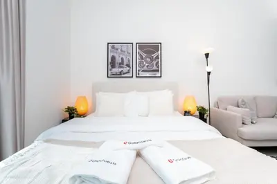 a white bed with two white towels on it at Tranquil Studio at Botanica in Dubai