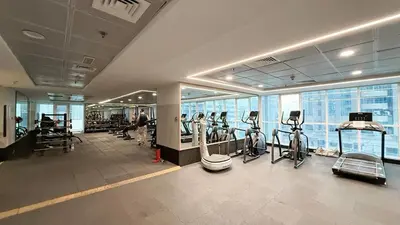 a gym with treadmills and ellipticals in a building at Luxury 2BR w Floating Bed in Dubai Marina Sulafa 4404 in Dubai