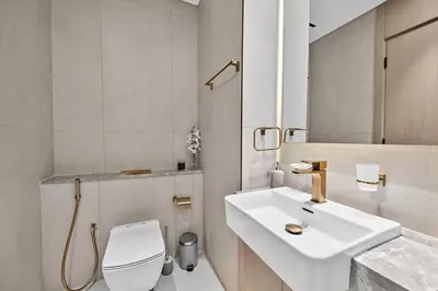 a bathroom with a white sink and a toilet at Dusk by Binghatti by Rentujemy in Dubai