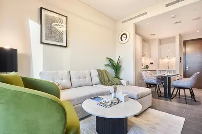 a living room with a couch and a table at STAY BY LATINEM Luxury 1BR Holiday Home CB 1414 Near Downtown in Dubai