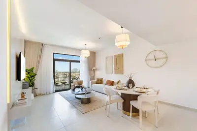 a white living room with a table and a couch at FAM Living -Madinat Jumeirah Living Apartment with Iconic Views in Dubai