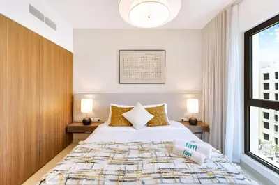 a bedroom with a large bed and a window at FAM Living -Madinat Jumeirah Living Apartment with Iconic Views in Dubai