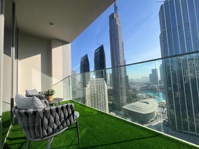 a balcony with a chair and a view of the city at Downtown Gem Apt, Burj View Bliss in Dubai