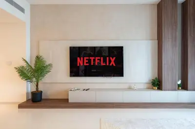 a living room with a television on a wall at KeyRock - Palm View Apt with Pool & Gym Access in Dubai