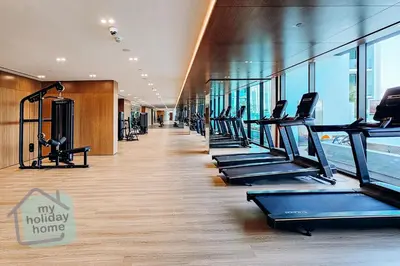 a gym with rows of treadmills in a building at Brand New 1BR Fully Furnished in Dubai
