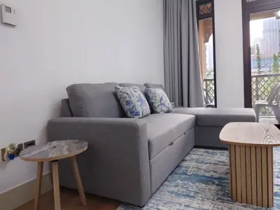 a living room with a couch and two tables at 5 Star Burj Khalifa View Spacious 2BR Next to Dubai Mall in Dubai
