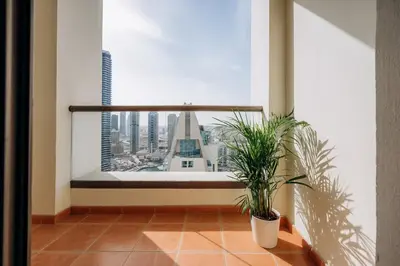 a potted plant in a room with a large window at Top Holiday Location - Canal View - Beach Access in Dubai