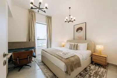 a bedroom with a bed and a desk and a chair at Top Holiday Location - Canal View - Beach Access in Dubai