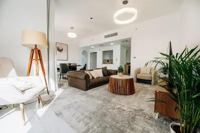 a living room with a couch and a table at Top Holiday Location - Canal View - Beach Access in Dubai