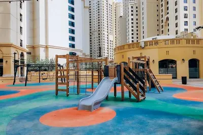 a playground with a slide in a city at Top Holiday Location - Canal View - Beach Access in Dubai