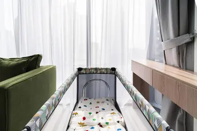 a baby crib in a room with a window at SettlerHomes - Liv Marina Luxe With Gym, Pool, Sauna in Dubai