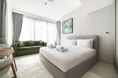 a hotel room with a bed and a couch at SettlerHomes - Liv Marina Luxe With Gym, Pool, Sauna in Dubai