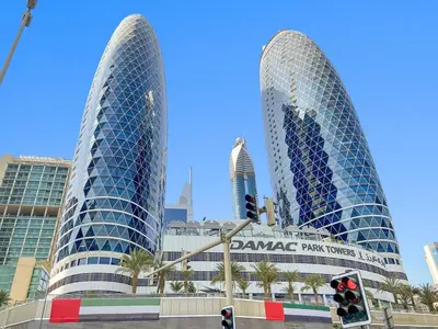 two tall buildings in a city with a traffic light at Beautiful Studio Prime location Pool & Gym in Dubai