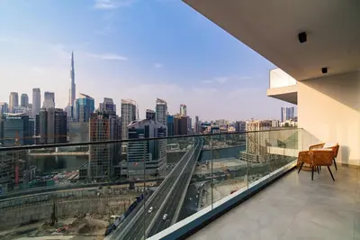 a balcony with a view of a city skyline at SettlerHomes - Lux 20F Stay With Gym, Pool & Cinema in Dubai