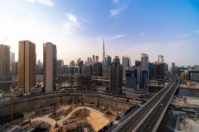an aerial view of a city with buildings and highways at SettlerHomes - Lux 20F Stay With Gym, Pool & Cinema in Dubai
