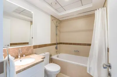 a bathroom with a tub and a toilet and a sink at RBA Holidays - Luxury Studio near Burj Khalifa - Downtown Dubai in Dubai