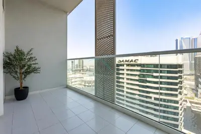a balcony with a view of a tall building at City View with Balcony Next to Dubai Water Canal, Walking Distance to Marine Transport Station, Easy Downtown Access, Reva Residences, Business Bay by Deluxe Holiday Homes in Dubai