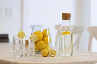 a bottle of lemonade next to two glasses of lemons at Sea & City View Apartment Dubai Marina - Ravello Living in Dubai