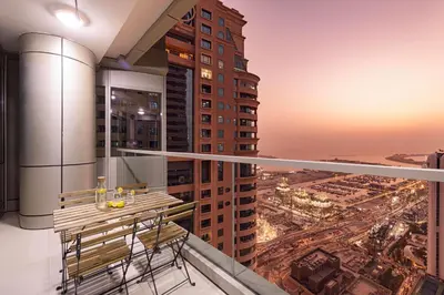 a balcony with a table and chairs on a building at Sea & City View Apartment Dubai Marina - Ravello Living in Dubai