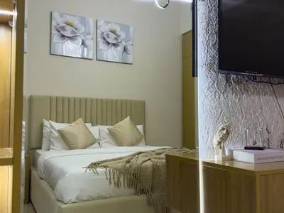 a bedroom with a bed and a tv on the wall at Luxury Redefined 1BR Apartment in Emaar 5242 in Dubai