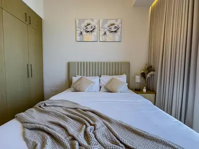 a bedroom with a bed with a blanket on it at Luxury Redefined 1BR Apartment in Emaar 5242 in Dubai
