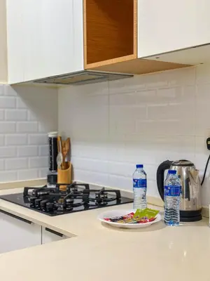 a plate of food and two bottles of water on a kitchen counter at Comfortable Studio Living in Dar Al Jawhara, JVC in Dubai