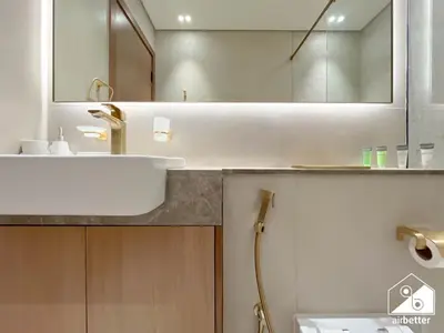 a bathroom with a sink and a mirror at Luxury 1BR l Balcony, Pool, Gym & Prime Location in Dubai