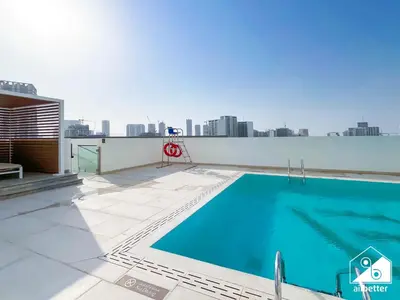 a swimming pool on the roof of a building at Modern 1BR in JVC l Pool, Gym, Parking in Dubai