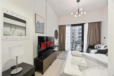 a living room with a bed and a tv at Elite Escape - Getaway in Azizi Riviera 26 in Dubai