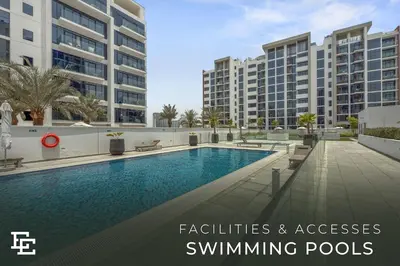 a swimming pool in front of some buildings at Elite Escape - Getaway in Azizi Riviera 26 in Dubai
