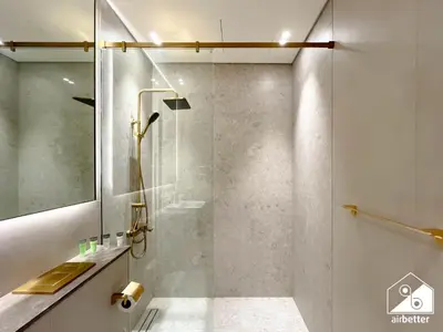 a bathroom with a shower with a glass door at Dubai JVC 1BR l Stylish Stay with Top Amenities in Dubai