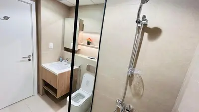 a bathroom with a shower and a toilet and a sink at studio in best community-podium level with terrace in Dubai