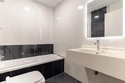 a white bathroom with a sink and a toilet at The Smart Concierge - Marina Wharf in Dubai