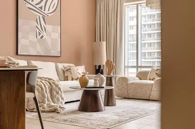 a living room with a couch and a table at The Smart Concierge - Burj Views in Dubai