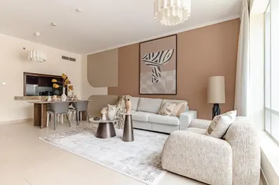 a living room with a couch and a table at The Smart Concierge - Burj Views in Dubai