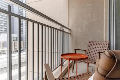 a balcony with a table and a chair at The Smart Concierge - Burj Views in Dubai