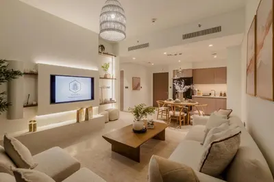 a living room with a couch and a table at Sarora One - Japandi-Inspired 2-Bedroom Apartment in Act One, Downtown Dubai with Balcony & Burj Khalifa View in Dubai