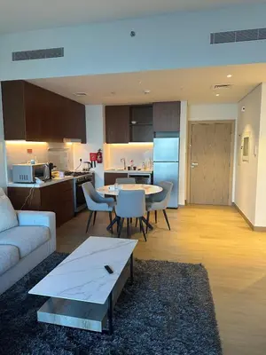 a living room and kitchen with a couch and a table at 2BR Apartment with full sea view & Burj Khalifa in Dubai