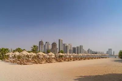 a row of chairs and umbrellas on a beach at Seven Palm Jumeirah Studio - Private Beach Access in Dubai