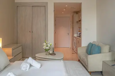 a living room with a bed and a couch at Seven Palm Jumeirah Studio - Private Beach Access in Dubai