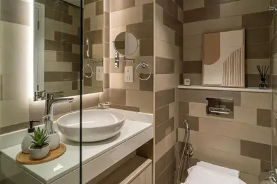 a bathroom with a sink and a glass shower at Seven Palm Jumeirah Studio - Private Beach Access in Dubai