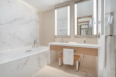 a bathroom with a sink and a mirror and a tub at Shukr شكر - Luxury 3BR with Panoramic Burj Khalifa & Fountain Views - Address Residence Dubai Opera - 2 Min Walk to Dubai Mall in Dubai