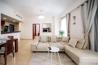 a living room with a couch and a table at Top Holiday Location - Walk to Beach - Free Pool & Gym in Dubai
